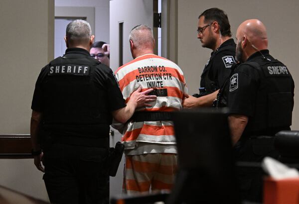 Colin Gray is escorted in handcuffs out of the courtroom after sentencing at Barrow County Superior Court in Winder on Thursday, July 30, 2026. Gray was sentenced Thursday to 15 years in prison two days after his son was sentenced to life in prison without the possibility of parole for Georgia’s deadliest school shooting. (Hyosub Shin/AJC)