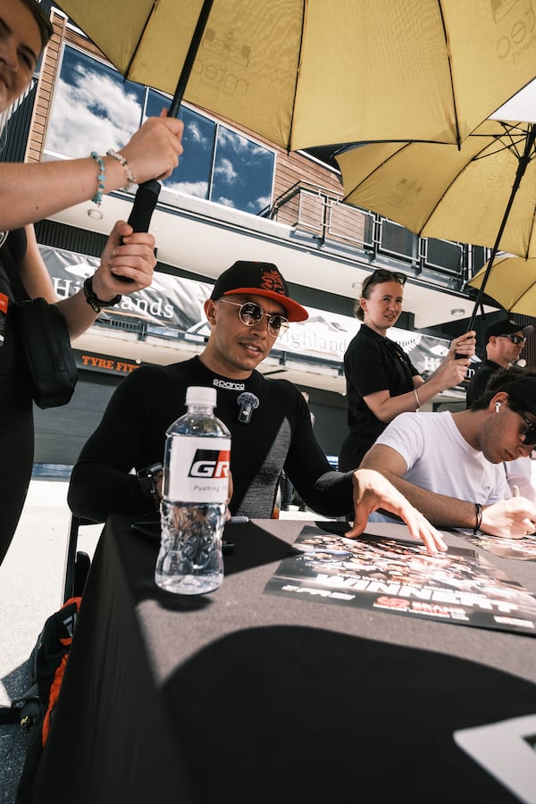 Shawn Rashid signs autographs in conjunction with the Formula Regional Oceania Championship's New Zealand Grand Prix at Highlands Motorsport Park-New Zealand, which was held Feb. 9, 2025. (Photo courtesy of Relay Film)