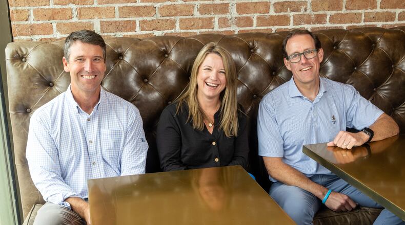 (Left to right) Wes Murrell, regional general superintendent, Jodi Taylor, chief HR officer and Greg Hunsberger, COO of planning & project delivery, are shown at the Brasfield & Gorrie offices in Atlanta. (Phil Skinner for the AJC)