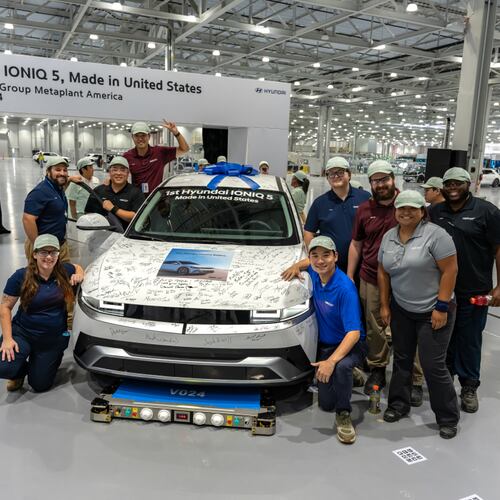 Hyundai Motor Group Metaplant America, LLC ("HMGMA") Meta Pros gather around an IONIQ 5 during the start of production celebration on Oct. 3, 2024. Each Meta Pro who attended signed the SUV to celebrate the first saleable vehicle off the line.