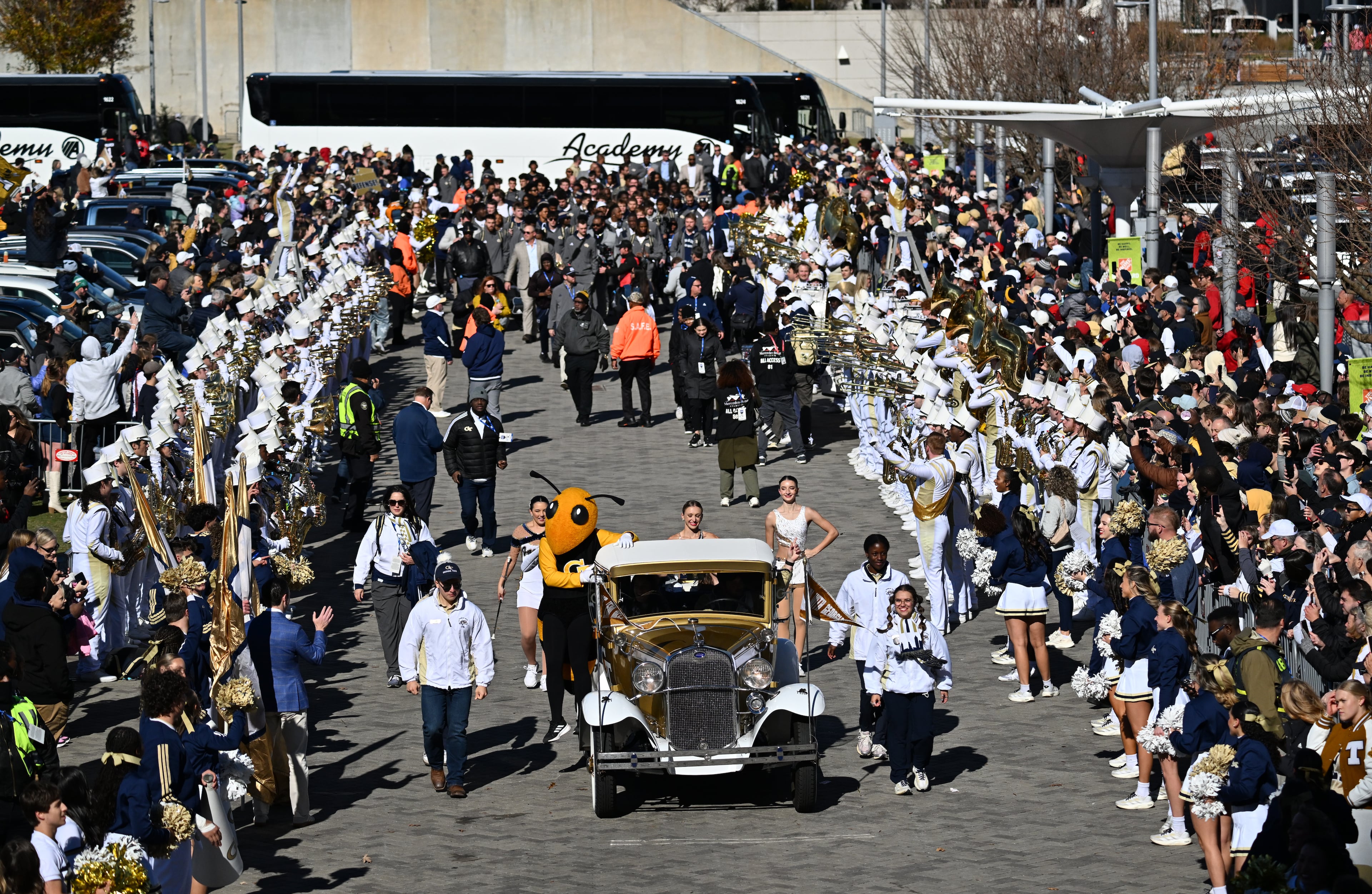 Georgia Tech's Ramblin' Wreck leads the band, cheerleaders, Buzz, players, and coaches before the start of the Georgia Tech vs Georgia football game at Mercedes-Benz Stadium, Friday, Nov. 28, 2025 in Atlanta. (Hyosub Shin/AJC)