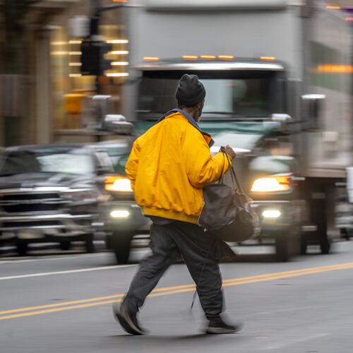 A pedestrian crosses busy Peachtree Street in downtown Atlanta on Wednesday, Feb 11, 2026. (Ben Hendren for the AJC)