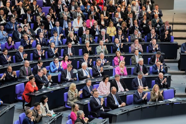 Leader of the Christian Democrats Friedrich Merz, third from right, listens to a debate iahead of a second round of vote at the German federal parliament, Bundestag, at the Reichstag building in Berlin, Germany, Tuesday, May 6, 2025. (AP Photo/Markus Schreiber)