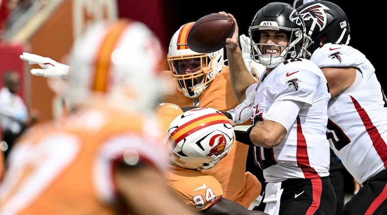 Falcons QB Kirk Cousins focuses on his target while being surrounded by several bodies on a play in Sunday's victory over the Bucs.