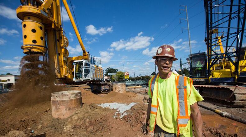 Work continues on the redevelopment of downtown Sandy Springs, where the city recently authorized eminent domain action to acquire land identified for parking. BRANDEN CAMP / For the AJC