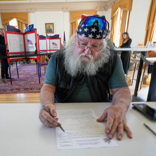 Jim McDonald fills out a form for early voting, Tuesday, Oct. 28, 2025, in Portland, Maine. (AP Photo/Robert F. Bukaty)