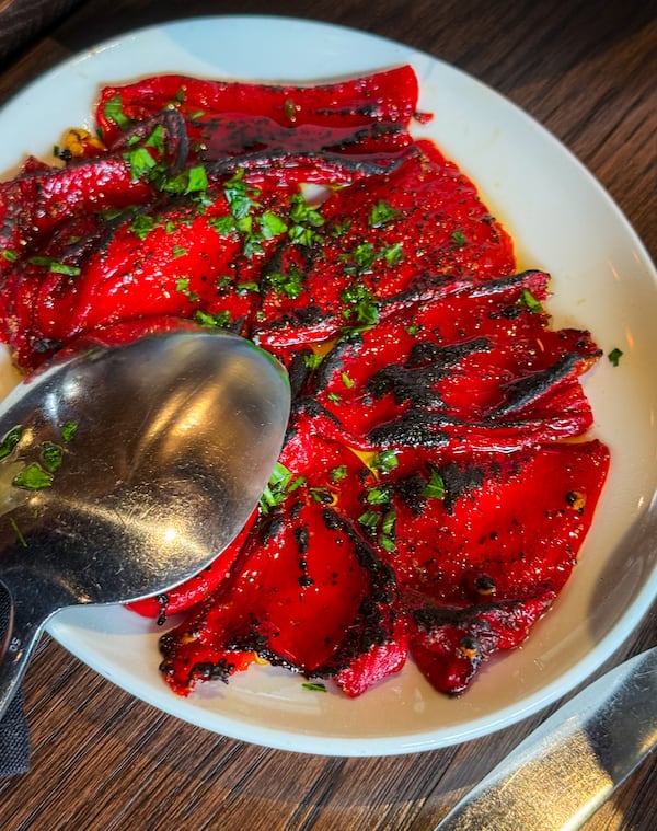 Charred piquillo peppers shrink to about half their original size when cooked in Krog Bar's coal-fired oven. (Henri Hollis/AJC)