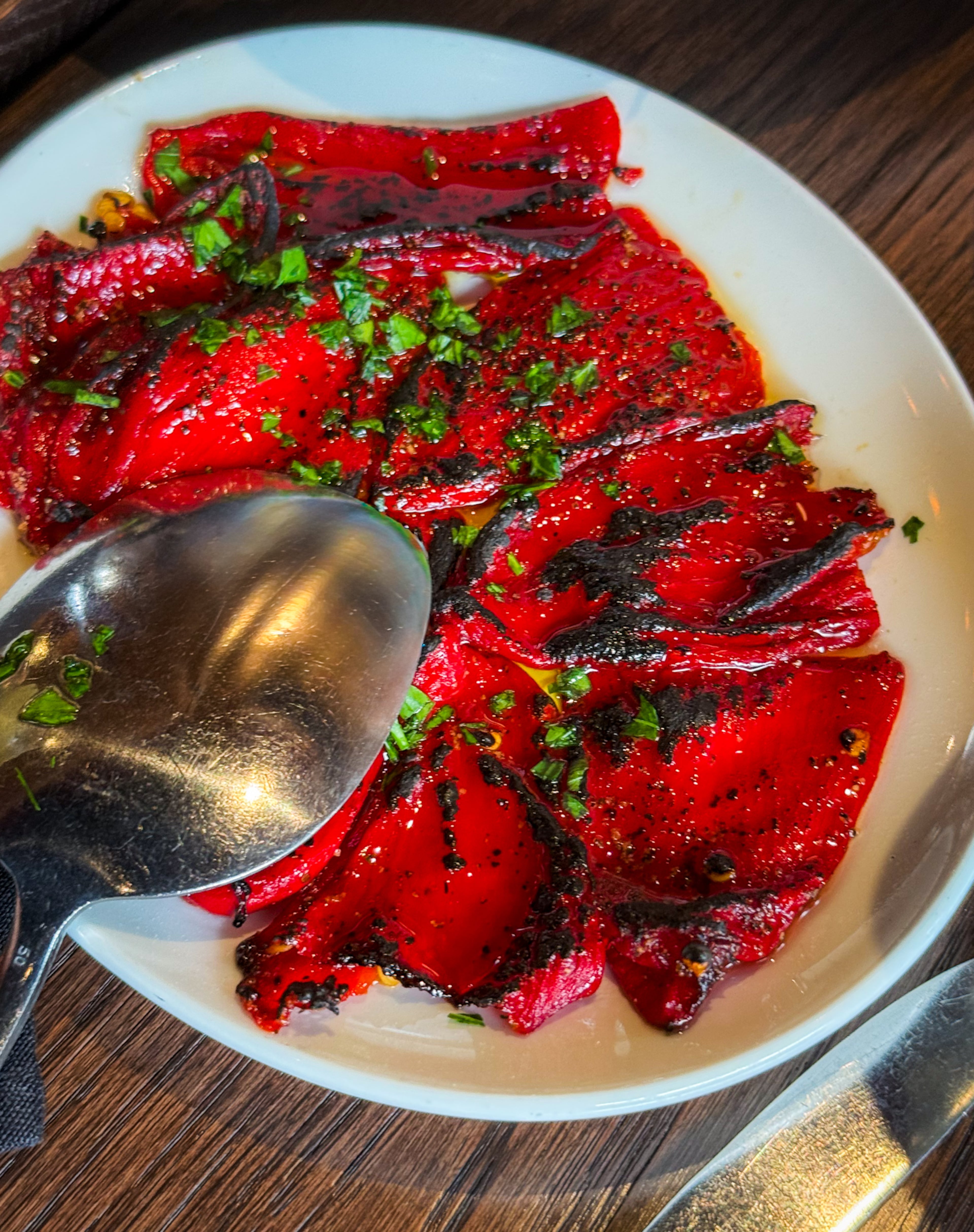 Charred piquillo peppers shrink to about half their original size when cooked in Krog Bar's coal-fired oven. (Henri Hollis/AJC)