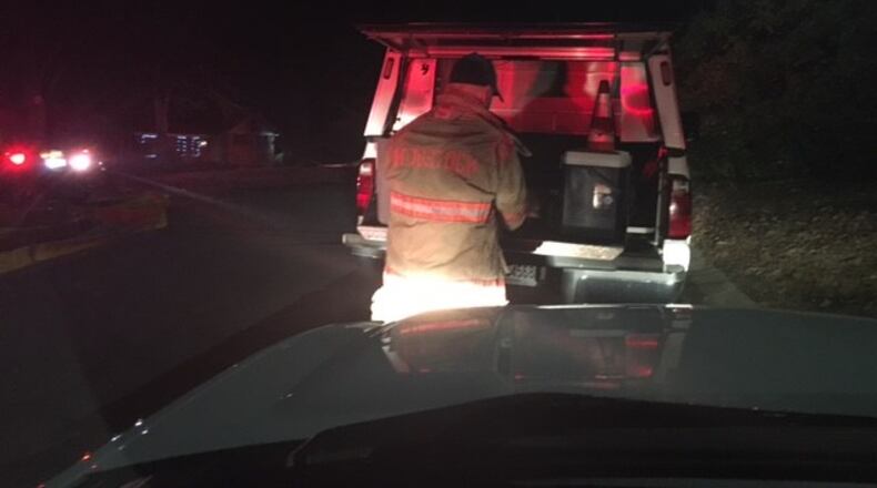 A responder works at the scene of a house fire in Woodstock. (Credit: Woodstock Fire Department)
