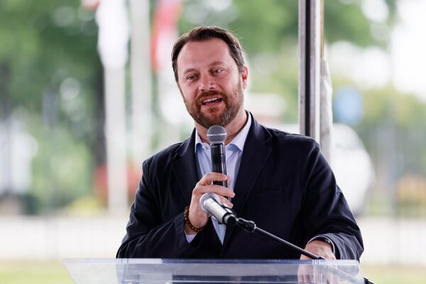 President Jimmy Carter's grandson, former state Sen. Jason Carter, speaks to the guests during a press conference organized by the Gateway85 Community Improvement District, Mall in Gwinnett on Tuesday, May 23. The event paid tribute to Jimmy Carter with banners unveiled along a 2-mile stretch of Jimmy Carter Blvd. Miguel Martinez /miguel.martinezjimenez@ajc.com