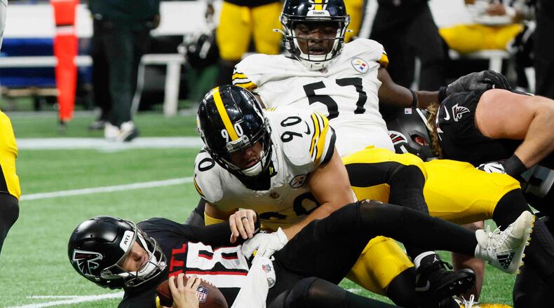 Atlanta Falcons quarterback Kirk Cousins (18) gets a sack in the game’s last play by Pittsburgh Steelers linebacker T.J. Watt (90) on Sunday, Sept. 8, at Mercedes-Benz Stadium in Atlanta. The Falcons lost 18-10. (Miguel Martinez/ AJC)
