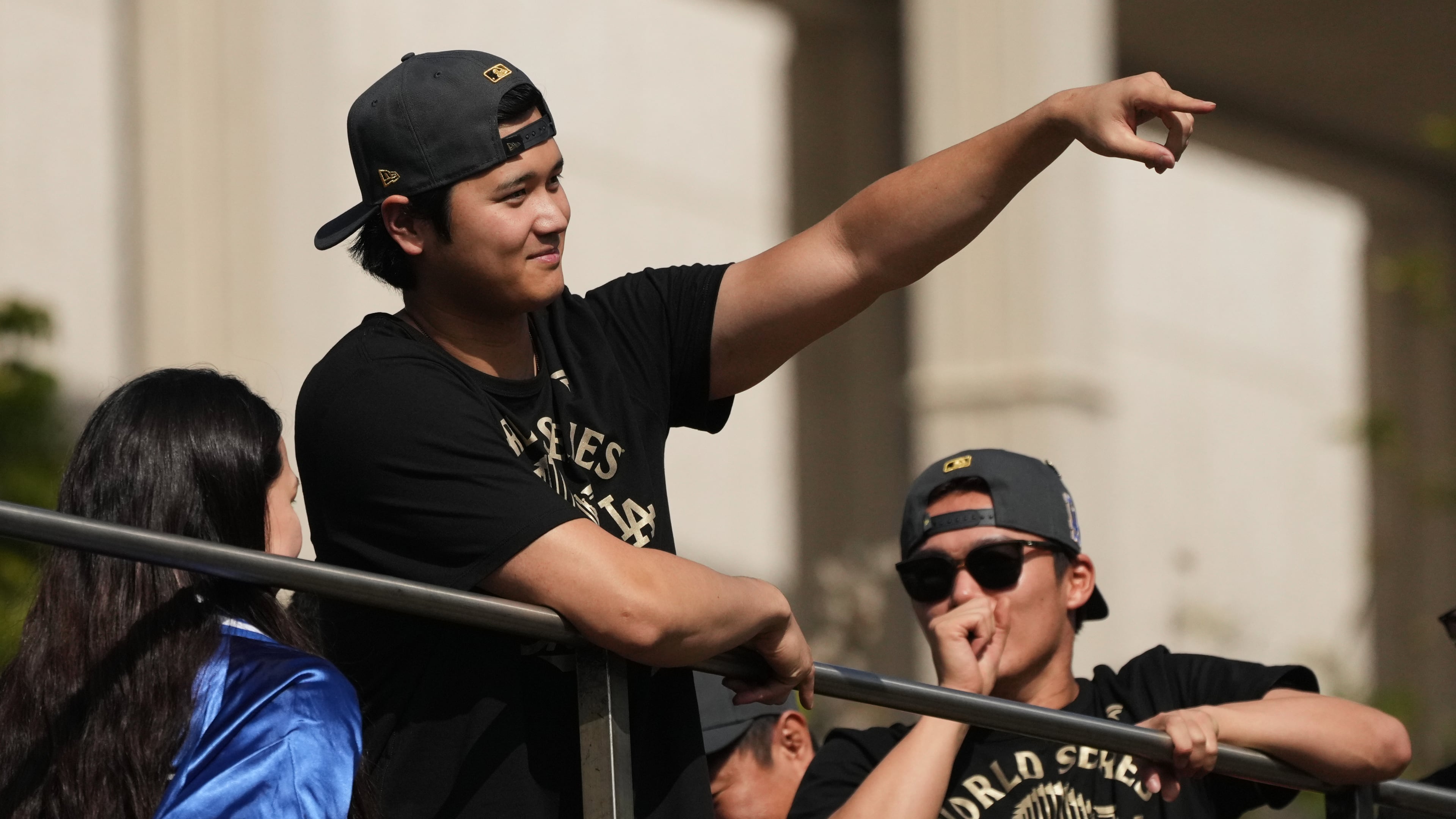 Los Angeles Dodgers' Shohei Ohtani points to fans during a parade to celebrate the baseball team's World Series win on Monday, Nov. 3, 2025, in Los Angeles. (AP Photo/Jae C. Hong)