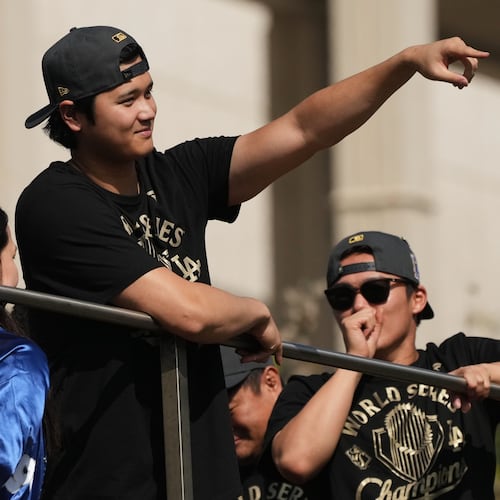 Los Angeles Dodgers' Shohei Ohtani points to fans during a parade to celebrate the baseball team's World Series win on Monday, Nov. 3, 2025, in Los Angeles. (AP Photo/Jae C. Hong)