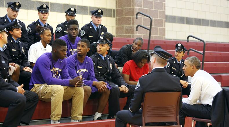 Then-President Barack Obama meets with students and law enforcement officers at the Ray and Joan Kroc Corps Community Center in Camden, New Jersey May 18, 2015. Obama was making the visit with law enforcement officials Monday to push efforts to encourage trust-building between police and the communities they serve. REUTERS/Jonathan Ernst