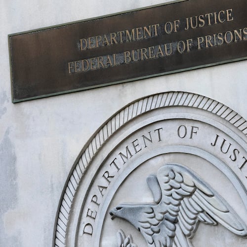 FILE - A sign for the Department of Justice Federal Bureau of Prisons is displayed at the Metropolitan Detention Center in the Brooklyn borough of New York on July 6, 2020. (AP Photo/Mark Lennihan, File)