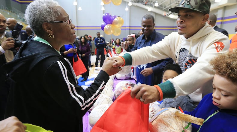A senior citizen thanks T.I. for her Thanksgiving produce during a turkey giveaway, held at the Adamsville Recreation Center.