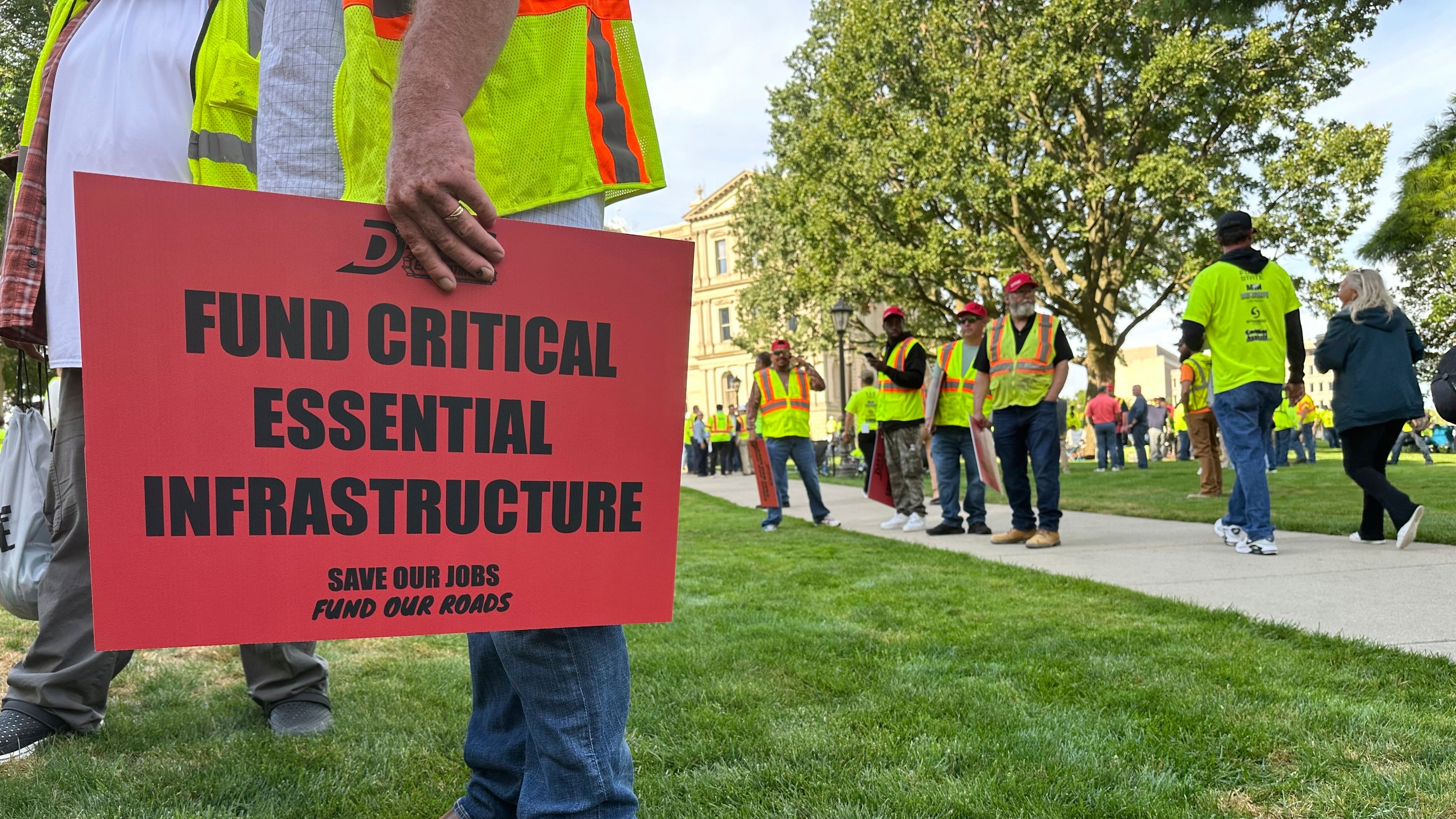 Construction workers gather at Michigan's statehouse in Lansing, Mich., Wednesday, Sept. 3, 2025, to call for a long-term road funding solution as a state government budget deadline approaches. (AP Photo/Isabella Volmert)