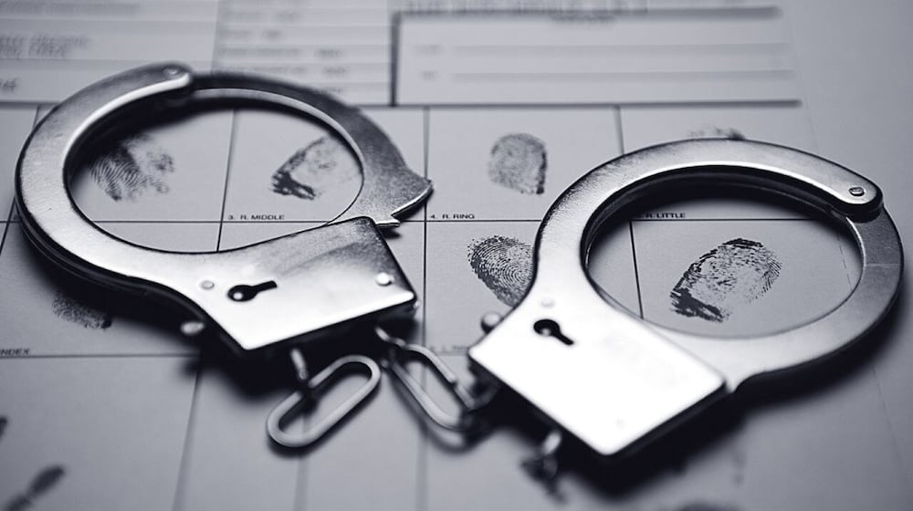 A woman was arrested Sunday after the remains of a child were found in the trunk of her vehicle, an arrest warrant said.