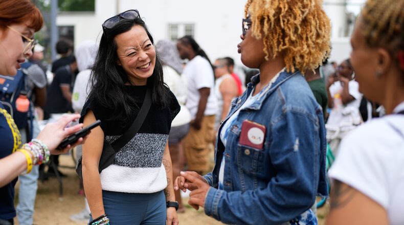 Democratic gubernatorial candidate Francesca Hong talks with Milwaukee residents during "We Outside" Annual Community Event at Metcalfe Park Rising, Friday, July 24, 2026, in Milwaukee. (AP Photo/Nam Y. Huh)
