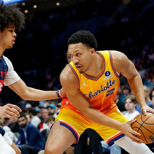 Charlotte Hornets forward Grant Williams (2) looks to drive against Washington Wizards guard Kyshawn George during the first half of an NBA basketball game in Charlotte, N.C., Saturday, Jan. 24, 2026. (AP Photo/Nell Redmond).