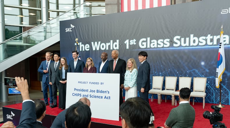 Georgia Sens. Jon Ossoff and Raphael Warnock attend an event in May 2024 at Absolics Inc. in Covington. (Ben Hendren for the AJC)
