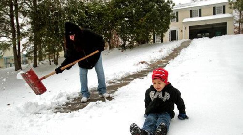 Snow days used to mean playing out in the cold stuff. With technology, though, many school systems have turned those times into work-from-home days. The AJC asks readers if every school should do that. AJC file photo