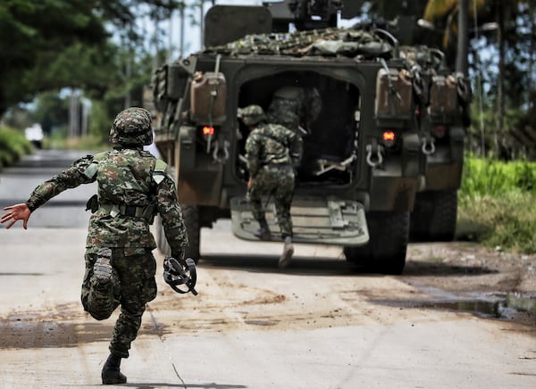 Soldiers patrol after a bomb explosion in Guachinte, Valle del Cauca, Colombia, Tuesday, June 10, 2025. (AP Photo/Santiago Saldarriaga)
