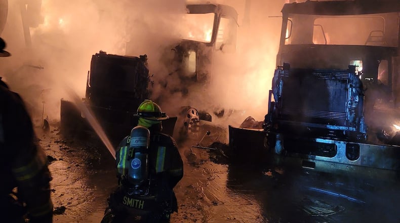 Multiple work vehicles owned by Ernst Concrete were found burning behind the Gwinnett County business Tuesday.