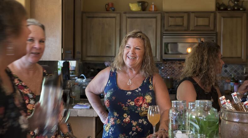 Marcie Dubreville chats with other Garden Goddesses while tasting founding goddess Susan Gouveia’s homemade mead at an informal goddess gathering at Gouveia’s Grass Valley, Calif. home on July 6, 2017. (Emily Zentner/Sacramento Bee/TNS)