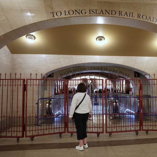 A passenger looks at a closed off entrance to the Long Island Rail Road at Grand Central station, Saturday, May 16, 2026, in New York, on the first day of a strike after five unions representing about half the LIRR's workforce walked off the job. (AP Photo/Heather Khalifa)