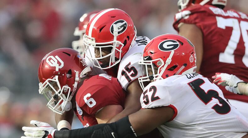 January 1, 2018 Pasadena: Georgia defenders DâAndre Walker and Tyler Clark sack Oklahoma quarterback Baker Mayfield during the second half in the College Football Playoff Semifinal at the Rose Bowl Game on Monday, January 1, 2018, in Pasadena. Curtis Compton/ccompton@ajc.com