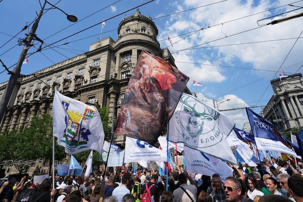 University students and people protest in front of the government building, six months after the deadly train station tragedy that sparked mass demonstrations against corruption, in Belgrade, Serbia, Thursday, May 1, 2025. (AP Photo/Darko Vojinovic)