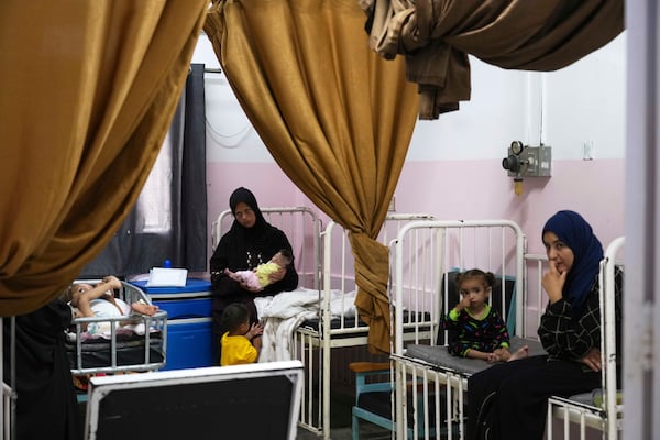 Mayar Al-Arja, 2, right, and five-month-old Yousef Al-Najjar, both suffering from malnutrition, are cared for by their mothers at the malnutrition clinic in Nasser Hospital, Khan Younis, Gaza, on Wednesday, May 21, 2025. (AP Photo/Abdel Kareem Hana)