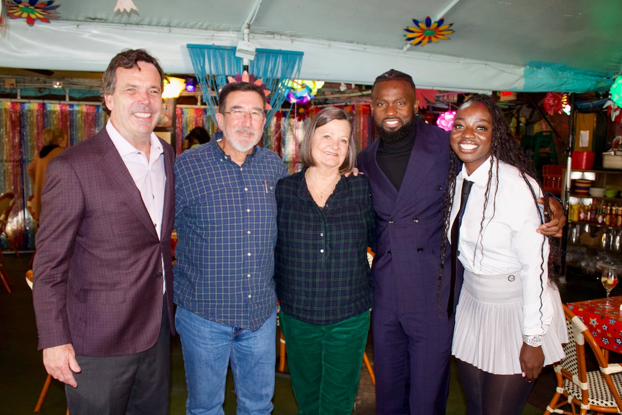 Cliff Oxford (from left), Michael Sheltra, Linay Thomas Sheltra, Amat Baba and Khady Thiam celebrate the sale of R. Thomas Grill at the restaurant. Linay Sheltra sold R. Thomas, the restaurant founded by her father, to Baba's hospitality company, the Teranga Group. (Courtesy of Andrea Fernandez)