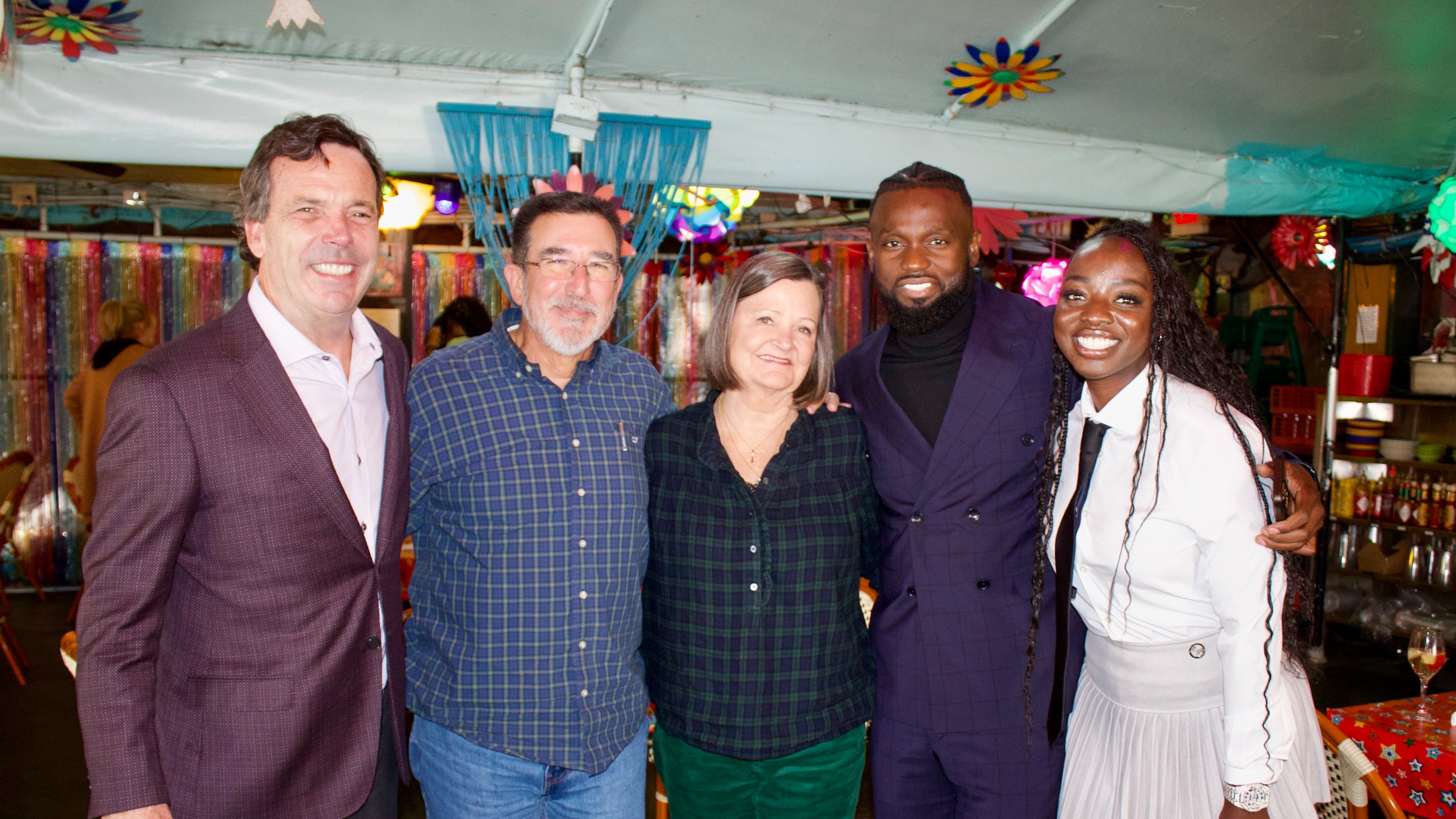 Cliff Oxford (from left), Michael Sheltra, Linay Thomas Sheltra, Amat Baba and Khady Thiam celebrate the sale of R. Thomas Grill at the restaurant. Linay Sheltra sold R. Thomas, the restaurant founded by her father, to Baba's hospitality company, the Teranga Group. (Courtesy of Andrea Fernandez)