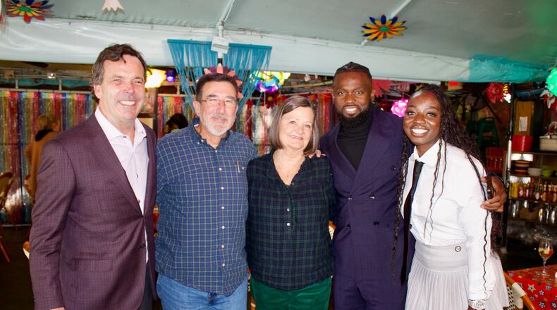 Cliff Oxford (from left), Michael Sheltra, Linay Thomas Sheltra, Amat Baba and Khady Thiam celebrate the sale of R. Thomas Grill at the restaurant. Linay Sheltra sold R. Thomas, the restaurant founded by her father, to Baba's hospitality company, the Teranga Group. (Courtesy of Andrea Fernandez)
