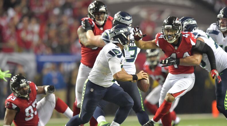 Seattle Seahawks quarterback Russell Wilson (3) moves a ball around to avoid a tackled by Atlanta Falcons outside linebacker Vic Beasley (44) in the second half during the NFC divisional playoffs at the Georgia Dome on Saturday, January 14, 2017. Atlanta Falcons won 36-20 over the Seattle Seahawks. HYOSUB SHIN / HSHIN@AJC.COM