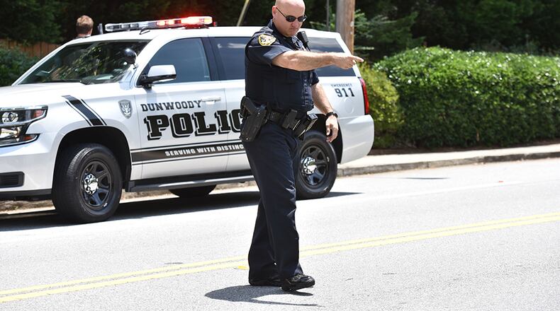 The Dunwoody Police Department warned on Facebook against smoking pot near police cars in a tounge-and-cheek post. Here, Dunwoody police Officer Christopher Irwin tells an alleged speeder to pull over to the side of the road in a file photo.