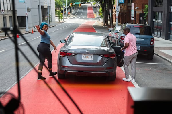 A driver waves after parking in the dedicated bus lane on MARTA’s new Rapid A-Line bus route in Atlanta on Saturday, April 18, 2026. (Abbey Cutrer/AJC)
