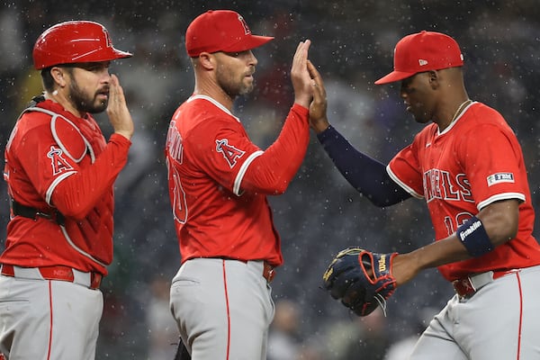 Los Angeles Angels' Travis d'Arnaud, left, Hunter Strickland, center, and Jorge Soler, right, react after defeating the New York Yankees in a baseball game Monday, June 16, 2025, in New York. (AP Photo/Pamela Smith)