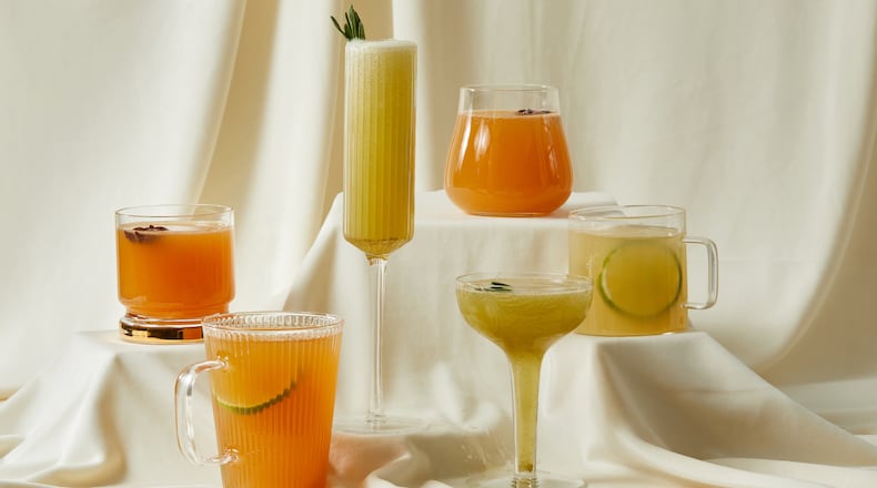From left: Spiced Apple-Rye Punch, Smoked Tea Toddy, Charred Lemon and Rosemary Gin Sparkler, Spiced Apple Punch, Charred Lemon and Rosemary Sparkler, Mezcal Hot Toddy. ((Prop styling by Morgan Locke, food styling by Kate Williams / Bailey Garrot for The Atlanta Journal-Constitution.)