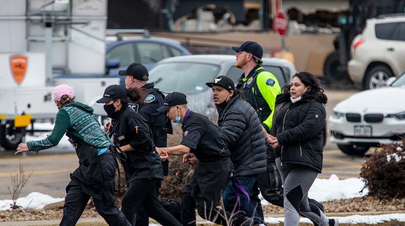 Shoppers are evacuated from a King Soopers grocery store after a gunman opened fire on March 22, 2021 in Boulder, Colorado. Dozens of police responded to the afternoon shooting in which at least one witness described three people who appeared to be wounded, according to published reports.