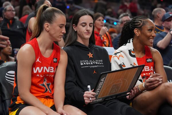 Indiana Fever's Caitlin Clark talks with New York Liberty's Sabrina Ionescu, left, during the first half of a WNBA All-Star basketball game, Saturday, July 19, 2025, in Indianapolis. (AP Photo/Michael Conroy)