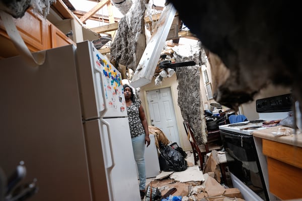 FILE - Natasha Ducre surveys the kitchen of her devastated home, which lost most of its roof during the passage of Hurricane Milton, in Palmetto, Fla., Oct. 10, 2024. (AP Photo/Rebecca Blackwell, File)