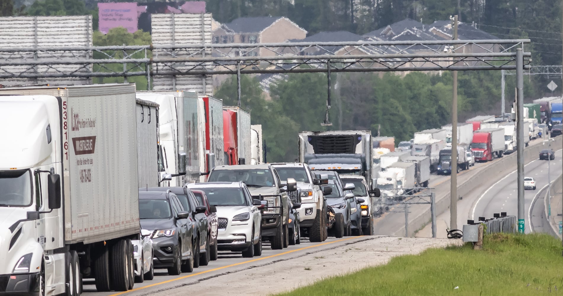 All lanes reopened on I-75 South in Henry County after a six hour investigation of a deadly crash involving multiple tractor-trailers that brought travel to a standstill Tuesday morning, April 16, 2024. The collision happened near mile marker 221, or just past Jodeco Road and before Jonesboro Road, at around 4:40 a.m., according to the Georgia Department of Transportation. The lanes were cleared by 11:20 a.m., GDOT stated, though traffic remained backed up for miles. Henry police confirmed at least one fatality. They did not release additional information about the extent of any other injuries. After the crash, a crane was used to lift a vehicle that appeared to have been pinned under one of the tractor-trailers. Several other big rigs remained on the shoulder of the interstate during the cleanup efforts. Police did not share details about what led to the wreck, as investigators processed the scene. Motorists were told to avoid the area. Backups extended for several miles, reaching I-675 as of 11:30 a.m. Commuters used U.S. 19/41, Ga. 42 and Ga. 155 as alternates, though traffic on those roads moved slowly, according to the WSB 24-hour Traffic Center. (Photo by John Spink/AJC)