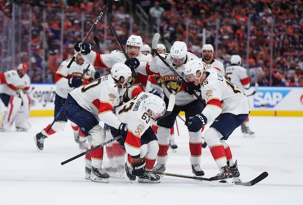 Florida Panthers' Brad Marchand (63) celebrates his game-winning goal against the Edmonton Oilers with teammates during the second overtime period in Game 2 of the NHL Stanley Cup final in Edmonton, on Friday, June 6, 2025. (Darryl Dyck/The Canadian Press via AP)
