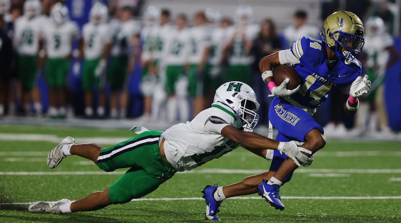 McEachern’s Zavion Harris (14) runs the ball during a NCAA High School football game between Harrison High School and McEachern High School at McEachern High School in  Powder Springs, GA., on Friday, October 4, 2024. (Photo/Jenn Finch, AJC)
