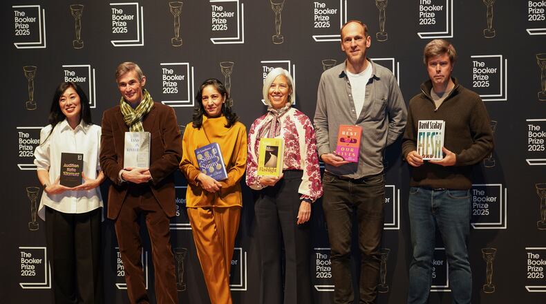The 6 shortlisted authors pose for photographs during a photocall for the Booker Prize, in London, Sunday, Nov. 9, 2025. (AP Photo/Alberto Pezzali)