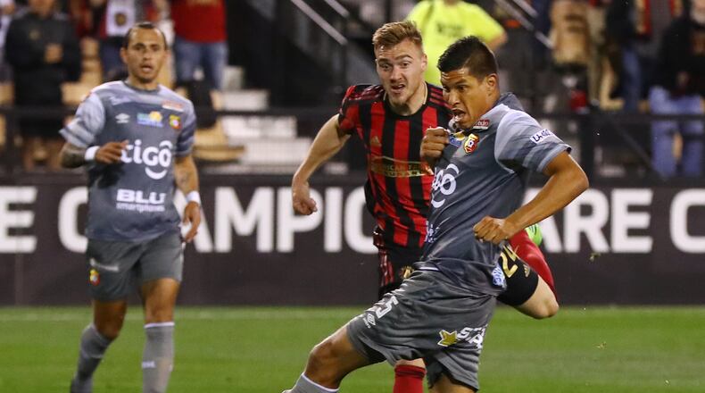 Feb. 28, 2019 Kennesaw: Atlanta United midfielder Julian Gressel scores a goal through the legs of C.S. Herediano midfielder Esteban Granados for a 2-0 lead in their Concacaf Champions League soccer match on Thursday, Feb. 28, 2019, in Kennesaw. Curtis Compton/ccompton@ajc.com