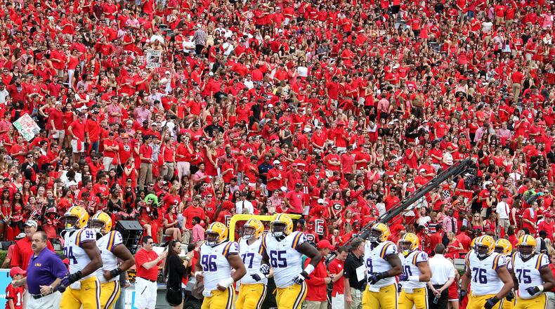 September 28, 2013 - Athens, Ga: Louisiana State University players take the field in front of a red out, University of Georgia fans, before their game at Sanford Stadium Saturday afternoon in Athens, Ga., September 28, 2013. JASON GETZ / JGETZ@AJC.COM SEC football fans deserve to see more conference opponents.